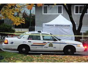 RCMP on the scene in Burnaby Wednesday, where a male driver was targeted in an early-morning shooting, and his car wound up crashing into a house in the 5900-block of Broadway. ‘The victim is well known to police and is affiliated with an organized crime group,’ says RCMP Sgt. Annie Linteau.