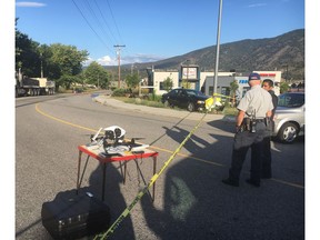 Police investigate the scene of a targeted drive-by shooting in Kelowna on Aug. 2. The victim, Reg. Purdom, is supposed to be a key witness in a U.S. drug case against another B.C. man.