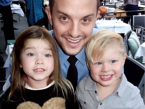 Probationary firefighter Jamie Olson backed Madeline Heck and Hudson Crook at a Vancouver Firefighter Charities benefit for the Snack for Kids program at their fathers' WildTale Coastal Grill.