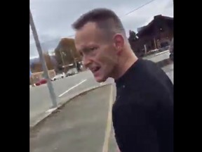 A suspect has turned himself in after a racist tirade was caught on video during a dispute over a parking spot in Abbotsford.