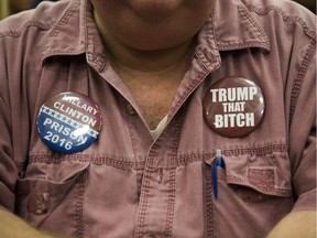 A supporter of Republican presidential nominee Donald Trump wears anti-Hillary Clinton buttons at a campaign event on October 1, 2016 at the Spooky Nook Sports Complex in Manheim, Pennsylvania.