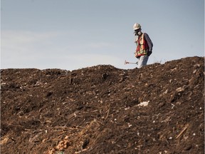 In this file photo, a worker measures the heat of a compost pile at Harvest Power in Richmond.