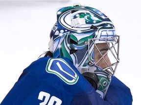 File: Vancouver Canucks' goalie Ryan Miller is struck by the puck during the overtime period of a pre-season NHL hockey game against the San Jose Sharks in Vancouver, B.C., on Sunday October 2, 2016.