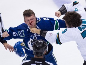 Vancouver Canucks' Derek Dorsett, left, and San Jose Sharks' Alex Gallant fight during the second period of a pre-season NHL hockey game in Vancouver, B.C., on Sunday October 2, 2016.