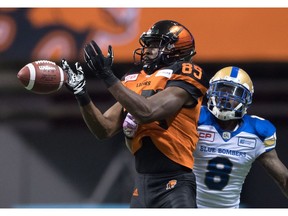 B.C. Lions' Shawn Gore, front, fails to make the reception as Winnipeg Blue Bombers' Chris Randle defends during the first half of a CFL football game in Vancouver, B.C., on Friday October 14, 2016.