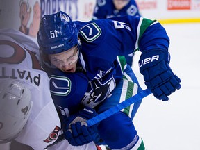 Troy Stecher checks the Senators' Tom Pyatt.