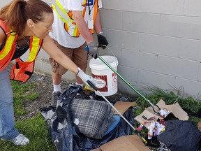 In this undated photo, members of the Lookout Society's Rig Dig program clean-up needles and trash in North Surrey. The program received an emergency fund from the Lookout Foundation that will allow it to continue operating until March 2017. — Lookout Emergency Aid Society