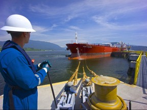 So Alberta’s oil is ‘landlocked’? Try telling that to this worker, looking out an oil tanker docked at the Westridge Marine Terminal in Burnaby, the terminus for Kinder Morgan’s Trans Mountain Pipeline that starts near Edmonton — in Alberta.