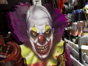 Halloween costumes and props, including a "scary" clown face, are seen for sale at a party store in the U.S.