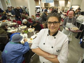 Seven-month-old Nevaeh Hall keeps her dad, Shawn, company as over 3,000 people took part in a traditional Thanksgiving dinner at the Union Gospel Mission on Monday.