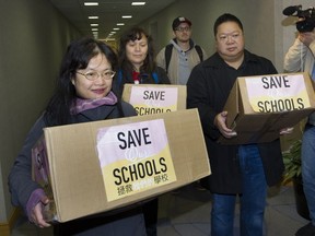 Opponents of proposed school closures in Vancouver deliver over 18,000 names in petitions to Education Minister Mike Bernier, one day after he fired Vancouver school trustees.