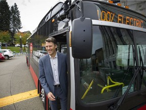 Mayor Gregor Robertson checks out a new electric bus outside of City Hall on Thursday.