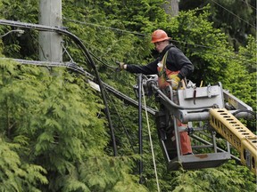 A Telus employee repairs cable after theft of Telus copper cable theft in Surrey in 2011. The telecommunications giant says it spends ‘tens of millions of dollars’ annually to protect its infrastructure from thieves.