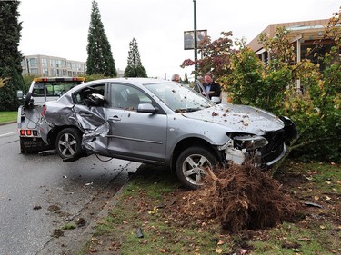 A car is towed having been involved in a stormy weather crash into a tree with another vehicle in the 5500 block of Cambie St, in Vancouver BC., October 13, 2016.