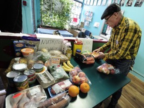 Fraser Doke lays out food (top of table, next to nutritious $70 diet) at the start of the Welfare Food Challenge in 2016.