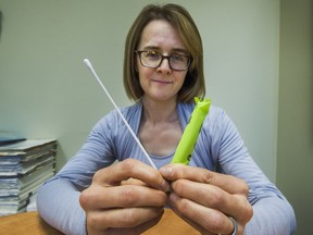 Dr. Anna Tinker with swab and tampon in Vancouver, BC., October 4, 2016. Dr. Anna tinker is leading a study on methods to help detect ovarian cancer. Women who enrol in the study are being asked to swab inside their vagina or insert a tampon to collect cells that are then examined to determine evidence of cancer.