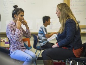 Jin Yusuf, 13, from Syria talks with Daniela Olmunger, one of six delegates from Sweden who talked with refugee students attending Charles Tupper Secondary in Vancouver, Oct. 5, 2016. (Arlen Redekop / PNG photo)