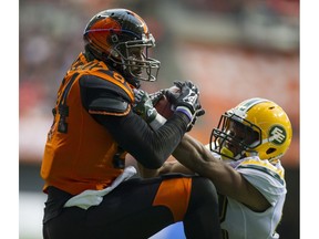 VANCOUVER October 22 2016.  BC Lions #84 Emmanuel Arceneaux hauls in a pass for a touchdown while pressured by Edmonton Eskimos #42 Tyler Thornton in a regular season CFL football game at BC Place, Vancouver, October 22 2016.  ( Gerry Kahrmann  /  PNG staff photo)  ( Prov / Sun Sports ) 00045818A  [PNG Merlin Archive]