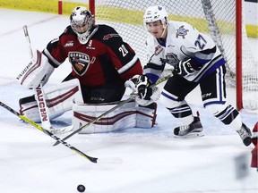 Goaltender Ryan Kubic #20 of the Vancouver Giants makes a save against Jared Dmitriw #27 of the Victoria Royals during the second period of their WHL game at the Langley Events Centre on October 5, 2016 in Langley, British Columbia, Canada.