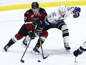 VANCOUVER, BC - OCTOBER 5: Brendan Semchuk #27 of the Vancouver Giants fights for the puck against Scott Walford #7 of the Victoria Royals during the third period of their WHL game at the Langley Events Centre on October 5, 2016 in Langley, British Columbia, Canada.