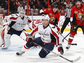 Karl Alzner of the Washington Capitals drops to the ice to block a shot in a game against the Ottawa Senators. Alzner is always among the league leaders in blocked shots.