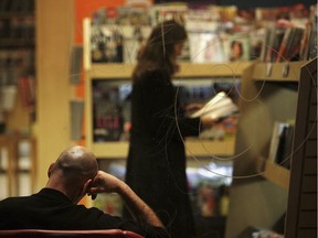 A man reads in a bookshop as darkness falls in Glasgow, Scotland.