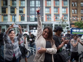 A woman reacts while listening during a demonstration calling for more safe-injection sites, in the Downtown Eastside of Vancouver back in June.