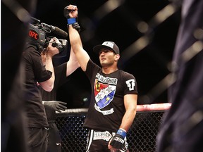 Dutch Mixed martial artist Gegard Mousasi celebrates after defeating United States' Mark Munoz during the Ultimate Fighting Championship (UFC) Fight Night at the O2 World in Berlin on May 31, 2014.