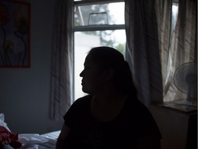 A mother from British Columbia, who can't be identified, poses for a photo in Vancouver, B.C., on Wednesday, Nov. 9, 2016. The British Columbia Ministry of Children and Family Development seized the woman's two children last month, for the second time, because of unexplained breaks in her son's legs. Since he was a baby, he has suffered at least a dozen broken bones.