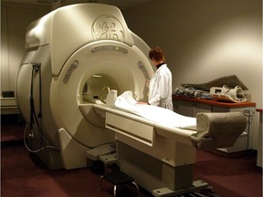 A technician operates an MRI machine.