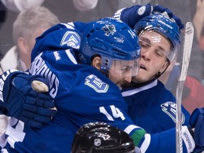 Vancouver Canucks' Bo Horvat, right, celebrates his goal against the Chicago Blackhawks with teammate Alex Burrows during the second period of an NHL hockey game in Vancouver, B.C., on Saturday November 19, 2016.