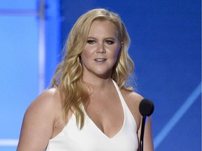 In this Jan. 17, 2016 file photo, Amy Schumer accepts the Critics' Choice MVP award at the 21st annual Critics' Choice Awards in Santa Monica, Calif. Comedy star Schumer has postponed several Canadian standup dates due to illness.