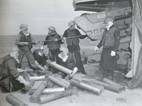 Andrew Irwin, second from right, and his crewmates cleaning guns on HMCS Algonquin, on D-Day, June 6, 1944.
