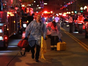 Medics respond to a multiple victim shooting near Third Avenue and Pike Street in downtown Seattle, Wednesday, Nov. 9, 2016. The Seattle Police Department reported one of the five shooting victims has life threatening injuries.