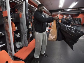 BC Lions offensive lineman Antonio Johnson cleans out his locker in the teams club house in Surrey on Tuesday. The Lions were eliminated for the season after losing to the Calgary Stampeders on Sunday.