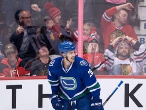 Spectators react behind Vancouver Canucks' Brandon Sutter after he scored against the Chicago Blackhawks during the second period of an NHL hockey game in Vancouver, B.C., on Saturday November 19, 2016.