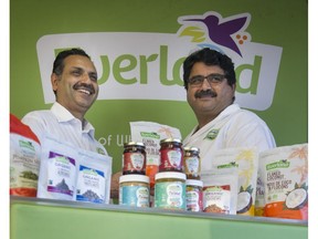 Rajinder Bagga, left, with his brother-in-law Vinod Walia and some of their Everland Natural Foods products at their manufacturing facility in Burnaby on Nov. 3, 2016.