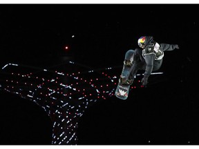 Canada's Mark McMorris performs on his way to take third place during the men's World Cup snowboard race in Rho, near Milan, Italy, Saturday, Nov. 12, 2016.