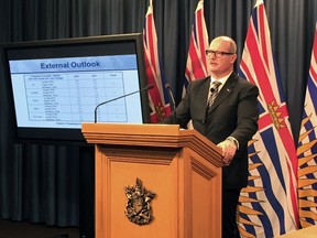 BC Finance Minister Mike de Jong delivers the second quarter financial results at the BC Legislature on Nov. 29, 2016.