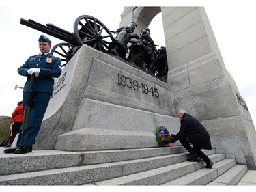 Dwight Ball, Premier of Newfoundland and Labrador, places a wreath during a Remembrance Day ceremony at the National War Memorial in Ottawa on Friday, Nov. 11, 2016.