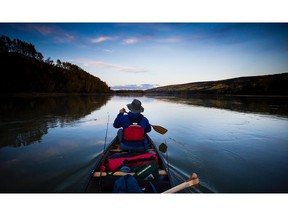 From the book: The Peace in Peril: The Real Cost of the Site C Dam, by Christopher Pollon and photographer Ben Nelms. Harbour Publishing. Photo credit, Ben Nelms. Cutline: Journalist Christopher Pollon paddles down the Peace River, as seen by his co-adventurer, photographer Ben Nelms  [PNG Merlin Archive]