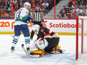 Mike Condon makes a save against Daniel Sedin.