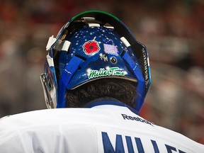 Goaltender Ryan Miller #30 of the Vancouver Canucks wears a red poppy decal on the back of his helmet to commemorate Remembrance Day during an NHL game against the Detroit Red Wings at Joe Louis Arena on November 10, 2016 in Detroit, Michigan. The Wings defeated the Canucks 3-1.