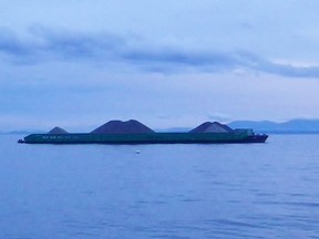 The Heiltsuk Nation in British Columbia says a barge has flipped and sunk not far from the site where a tug that ran aground last month still awaits removal. A gravel barge in the Salish Sea is shown in this file photo.