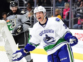 Jannik Hansen of the Canucks reacts to the referee for a penalty in front of Drew Doughty. (Harry How/Getty Images)