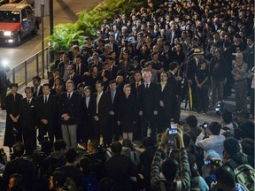 Hundreds of Hong Kong lawyers take part in a silent march to protest a ruling by China which effectively bars two pro-independence legislators from taking office.