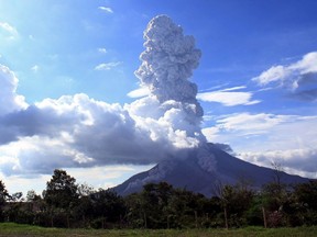 Mount Sinabung volcano spews volcanic ash into the air, as seen from the village of Simpangempat in Karo district, North Sumatra province on November 11, 2016.