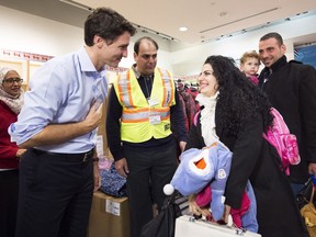 Prime Minister Justin Trudeau greets new Syrian refugees at Pearson International Airport in Toronto last December. SUCCESS immigration services believes anti-immigrant sentiment is on the rise in B.C.