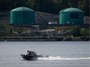A fishing boat in North Vancouver passes Kinder Morgan’s Westridge Marine Terminal in Burnaby, on the shores of Burrard Inlet. This would be the terminus of the Trans Mountain pipeline.