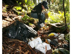 Kathleen Woodruff picks up garbage dumped near Goldstream Provincial Park.